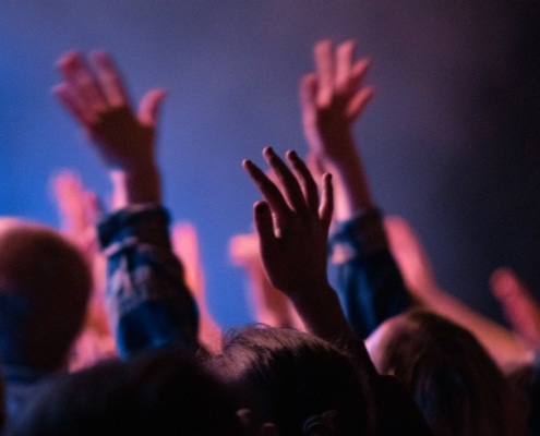 Pentecostal Christians actively praising God as dedicated church members supporting His work.