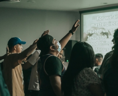 Pentecostal Christians worshiping, representing the spirit and faith we share at Victory Chapel in New Hampshire.